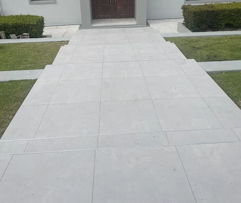 Large-format exterior pathway tiling at a house entrance