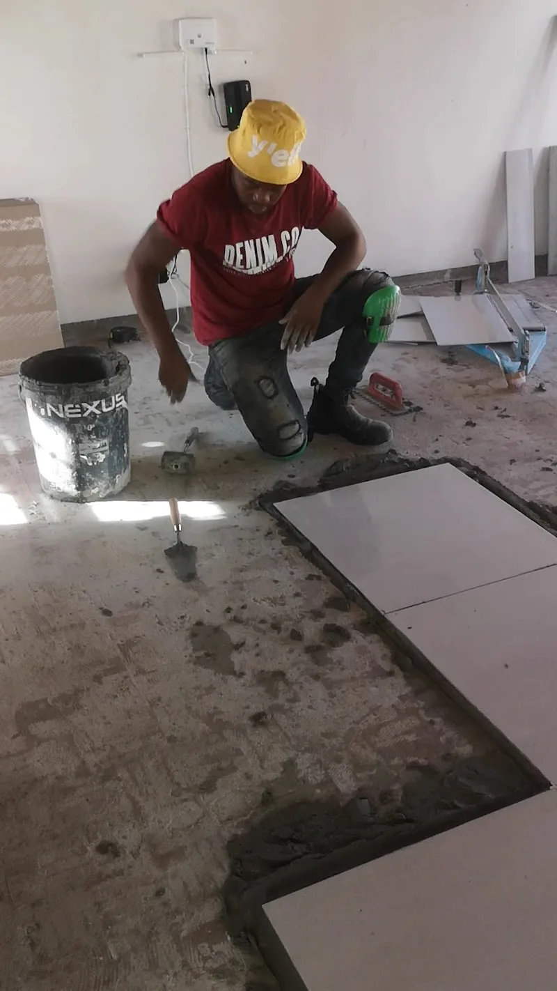 Tiler working on floor preparation and tile installation